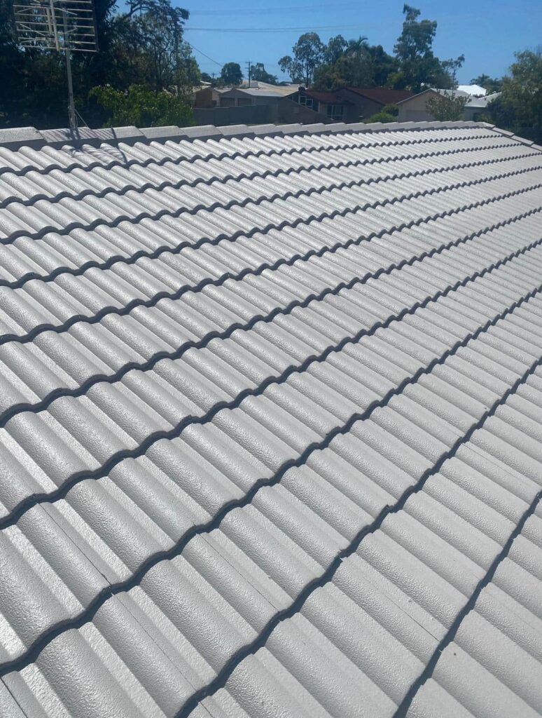 A freshly painted grey tile roof after restoration